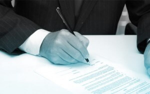 COVID-19 image of hand signing a document