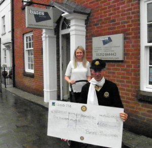 Laura of Bates Solicitors helps push along the Pram Race with a generous sponsorship cheque